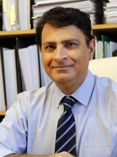 Photo of Dr Bodani sitting at a desk