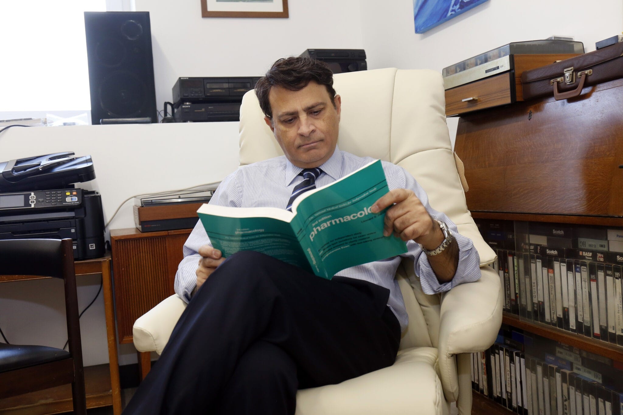 Photo of Dr Bodani reading a publication